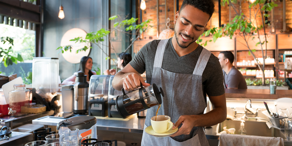 barista pouring coffee
