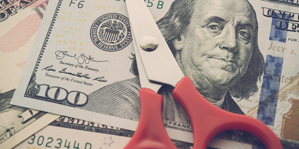 money and a pair of scissors