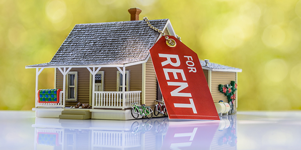 small house with a for rent sign