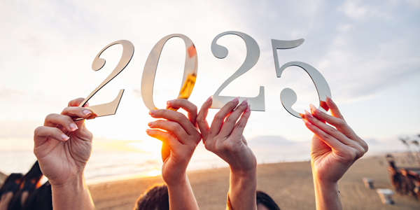 hands holding cut out numbers - 2025